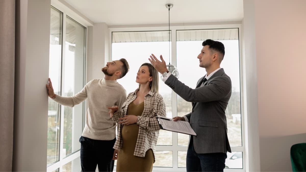 Property inspector reviewing damage with homeowners during an interior inspection